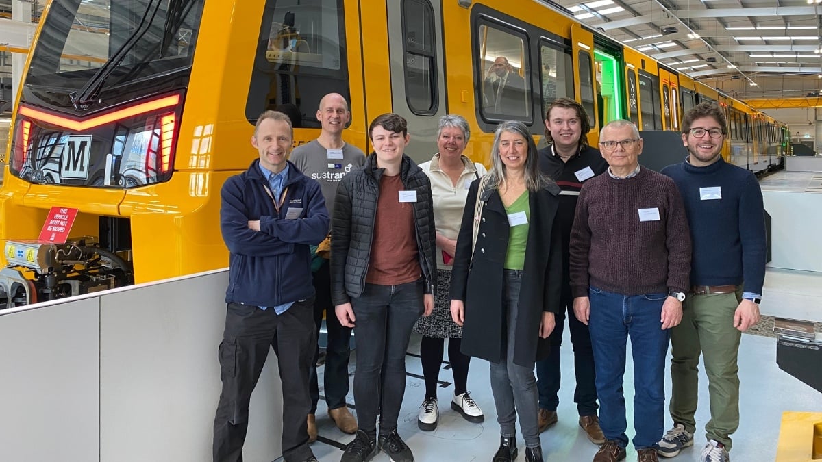 Image shows the research team standing in front of one of the new Metro carriages