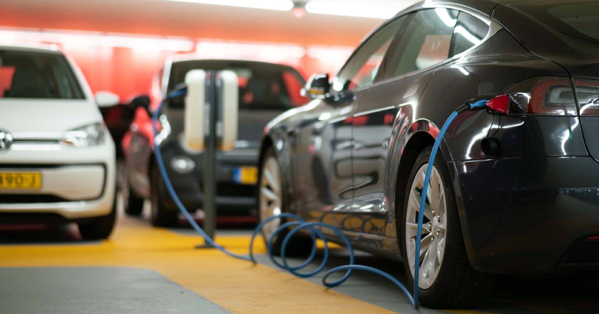 An electric vehicle being charged at a car park